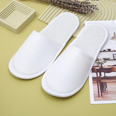 China Exquisite Disposable Hotel Amenities Personalized Closed Toe Spa Washable Napped Fabric White Indoor Soft Hotel Slippers for sale