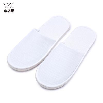 China Exquisite Disposable Hotel Amenities Disposable 7mm EVA Sole Thicker Sponge White Waffle Hotel Slippers With Hotel Logo for sale