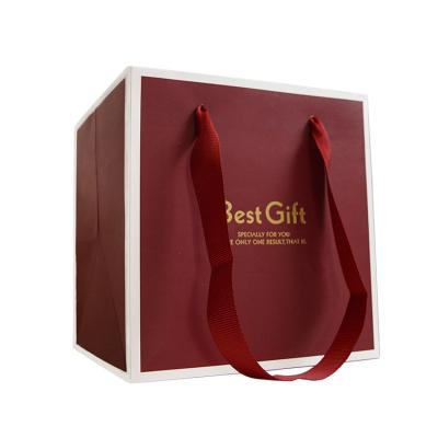 China Custom Made Fancy Logo Jewelry Packaging Shopping Gift Red Printed Paper Bag Made With Ribbon Handles for sale