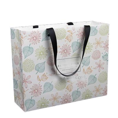 China Handmade luxury hot sales custom packaging candy bags with logo flower printing cute bags for packaging for sale