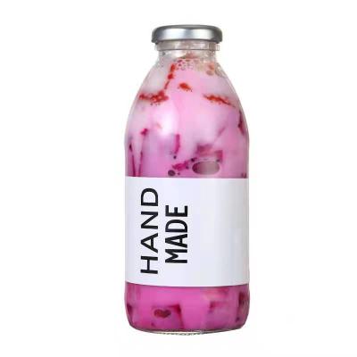 China 16OZ Round Glass Bottles Round Empty Fresh Fruit Milk Juicy Drinks With Twist Off Lids for sale