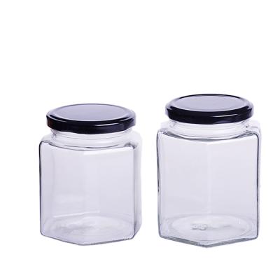 China Wholesale Glass 60g Hexagonal 90g 120g 150g Food Grade Honey Jar With Screw Metal Lid for sale