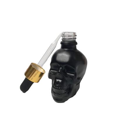 Cina Hot Sale Black Dropper Bottle Skull Shape Bottle Empty Personal Care Glass Bottle in vendita