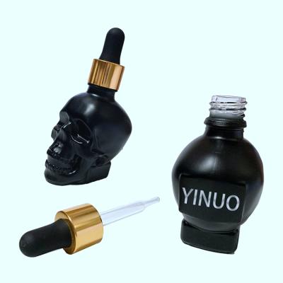 China Cosmetic high quality luxury skull shape glass dropper bottles with cheap price for sale