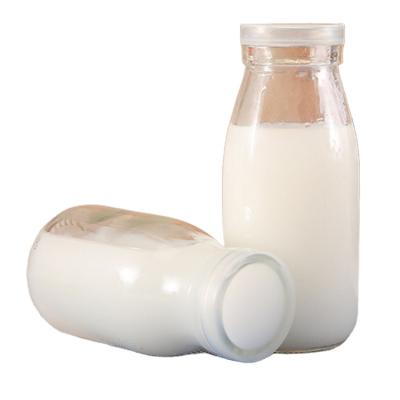 China Custom Beverage Storage Glass Milk Bottles With Metal Lids for sale