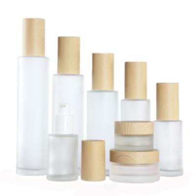 China Wholesale Cosmetic Bottle Glass Jars Skin Care Cosmetic Packaging Set Frost Cream Jars And Spray Lotion Bottles With Bamboo Lid for sale