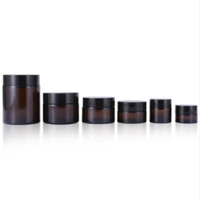 China Factory Wholesale Cosmetic Custom Round Shape Amber Glass Cosmetic Face Eye Cream Jar With Black Plastic Screw Cap for sale