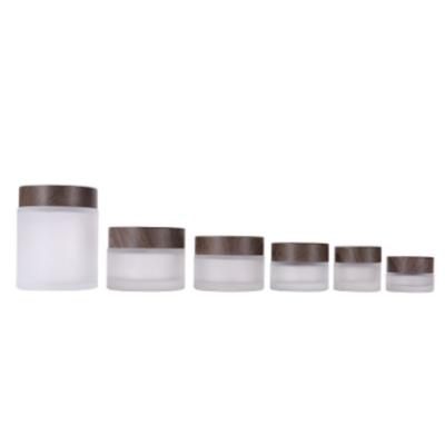 China Factory Wholesale Cosmetic Custom Round Shape Face Eye Cream Frosted Glass Cosmetic Jar With Bamboo Lid for sale