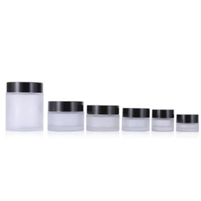 China Factory Wholesale Cosmetic Custom Round Shape Face Eye Cream Frosted Glass Cosmetic Jar With Black Plastic Cover for sale