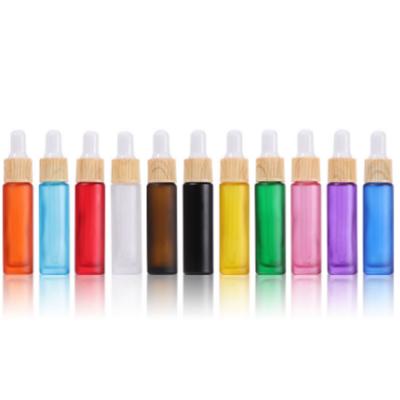 China Cosmetic Manufacturer 10ml Stain Ring Color Dropper Bottle Wooden Nipple Bottle for sale