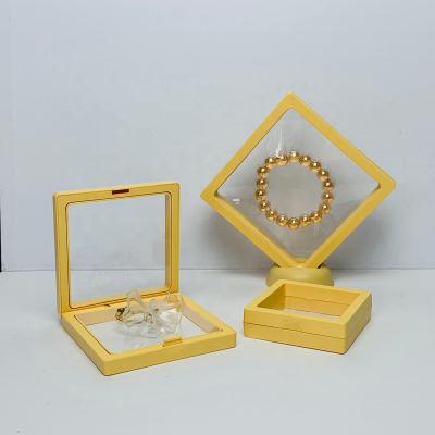 China Portable Light Yellow Transparent Floating Pendant Organizer Storge Box Membrane 3D Frame Display Jewelry Coin Display Case Gift Box Packaging for sale