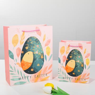 China Recycled Materials boutique pink packaging gold gift paper shopping foil bag with printed ribbon Cartoon dinosaur boy Easter butterfly for sale