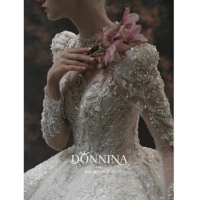 China Dubai Crystal Metal Sequin Backless Shiny Beaded Wedding Dresses Big Tail Wedding Dresses Long Sleeves Anti-Static Luxury White Neck for sale