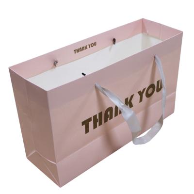 China 100 Piece Recyclable Custom Decorative Paper Door Gift Bag With Handles Bags for sale