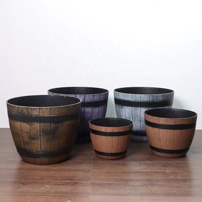 China CLASSIC High Density Plastic Wooden Round Rustic Round Flower Pot Resin Flower Pots Barrel Planters Outdoor Large Barrel Planters for sale