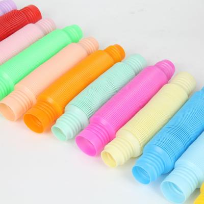 China Color Border Macaron Candy Tube Pop Tube Kids Plastic Adult Corrugated DIY Macaron Color Decompression Stretch Tube for sale