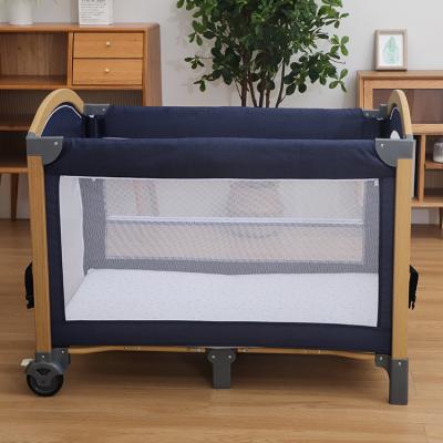 China Eco-Friendly Materials Multifunctional Foldable Portable Baby Crib Luxury Crib Hutch With Two Wheels Baby Playpen for sale