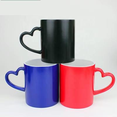 China Viable Magic Ceramic Black Color Changing Mug Heart Shape Mug 11oz Sublimation Coffee Mug for sale