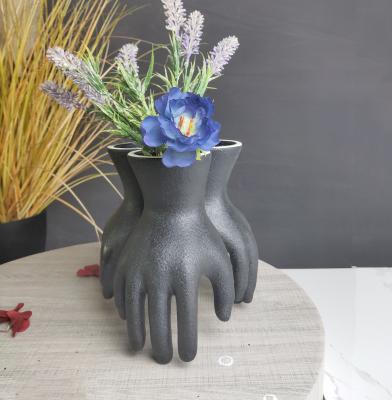 China 2021 new folk art design black color hand shape ceramic vase for centerpiece home decoration for sale