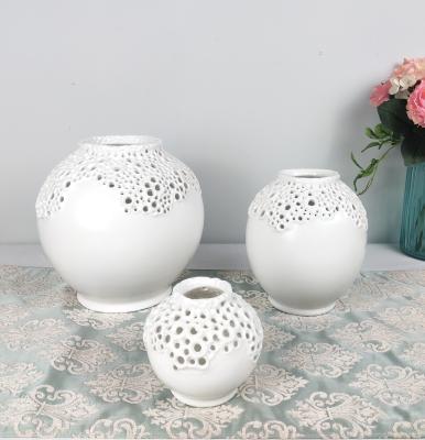 China Contemporary Elegant Centerpiece Matte White Hollow Decor Design Ceramic Vase for sale