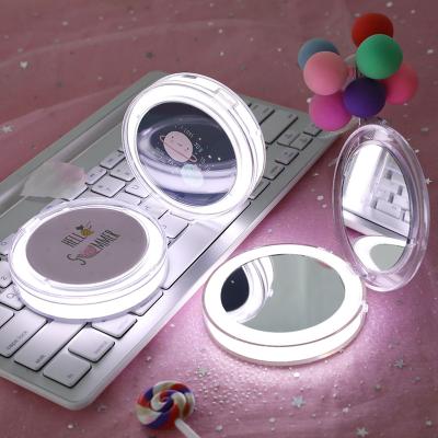 China Fashion Girl Beauty Makeup Mirror Espelho Handbags Fill Light Round LED Portable Handheld Makeup Mirror USB Lovely Mini Double Sided Makeup Mirror for sale