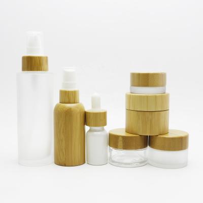 China 4oz cosmetic 5ml 10ml 15ml 30ml 50ml 100ml 120ml in stock clear frosted glass jar for skin care cosmetic cream with bamboo lid BP-A9 for sale