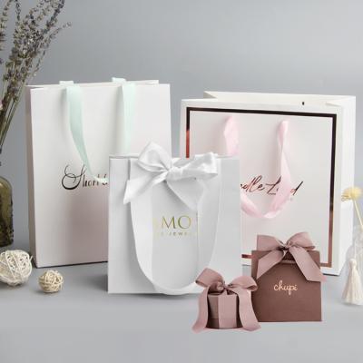 China Luxury Custom Recyclable Clean Printed Logo Apparel Shopping Jewelry Wedding Gift Packaging Paper Bag Retail Necklace Boutique For Clothes for sale