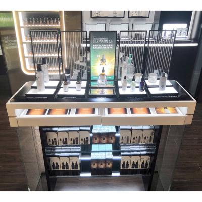 China Custom Cosmetic Shop Decoration Retail Shops Metal Retail Store Display Rack Backwall Display Stands With Tester Bar for sale