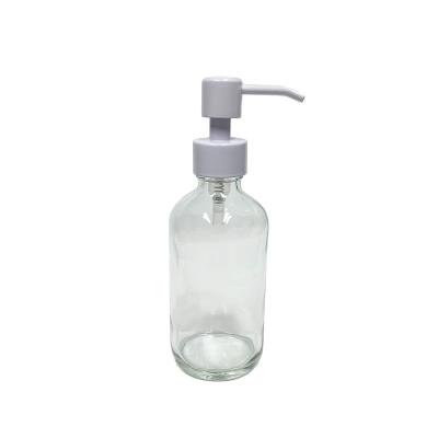 China Personal Care 8oz 250ml Clear Boston Round Glass Bottle With White Stainless Steel Metal Lotion Pump Dispenser for sale