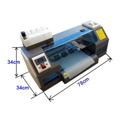 China Fabrik 30cm DTF Drucker Multifunktionaler Tintenstrahl T-Shirt Drucker A3 2 XP600 Kopf mit Pulvershaker zu verkaufen