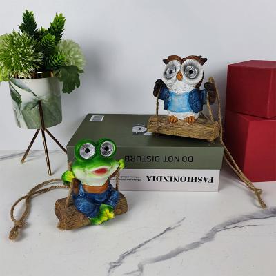 China Europe Resin Cute Craft Figurine Solar Animal Play On Hemp Rope Swings Garden Creative Wall Home Decor for sale