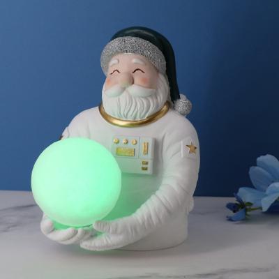 China Traditional Creative Resin Open Christmas Astronaut Holding LED Ball Decorations For Home Decor for sale