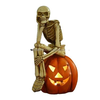 China Halloween Decoration Light Product 2022 New One Set Resin Human Skulls Sits On Pumpkin Led Light For Halloween Decoration for sale