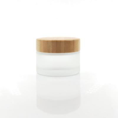 China 50g 50ml 1.7oz bamboo lid cosmetic organic empty glass cosmetic jar bamboo jar with customized packaging and logo for sale