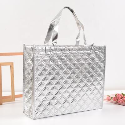 China Stylish Simple Silver White Covered Logo Nonwoven Clothing Shopping Tote Bag for sale