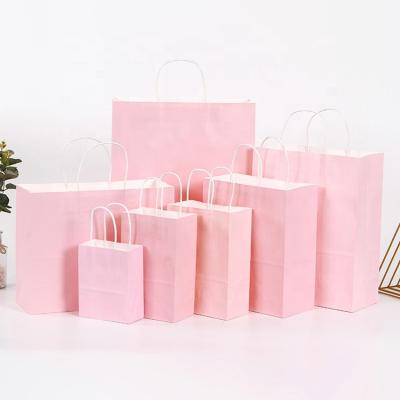 China Recycled Materials Custom Shopping Clothing Carry Bag Pink Kraft Paper Gift Wrapping Paper Bag for sale