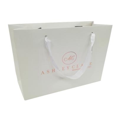 China Recyclable Embossing And Logo Mounted Gold Foil Custom Printed Gift Paper Bag for sale