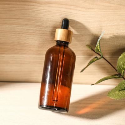 China Reusable Cosmetic Glass Container Essential Oil Dropper Bottle With Bamboo Cap for sale