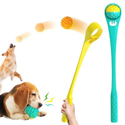 China Pet Stocked Toy Squeaky Rubber Ball Chew Toys Tooth Cleaning Leak Food Dog Toys with Throw Rod for sale