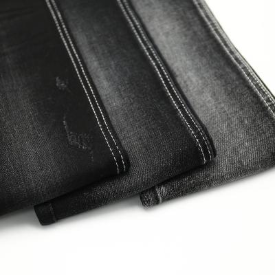 China Breathable Vintage Salvage Good Stretch Raw Denim Fabric Black Stock Lot In China for sale