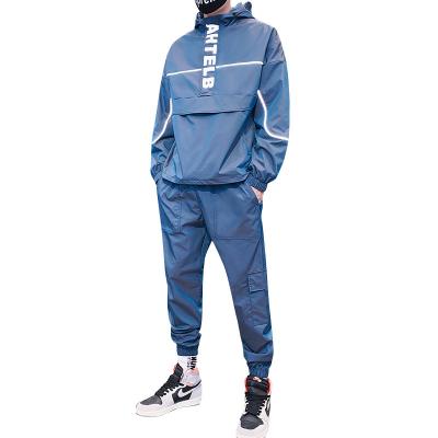 China 100% Polyester Jogging Suit Breathable Hooded Functional Cargo Two Piece Logo Letter Embroidery Reflective Marks Color Block Sweatsuit for sale