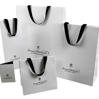 China Recyclable Silver Paper Sliver Handle Appearance Shopping Paper Bags for sale