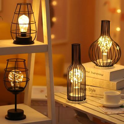 China New-designed Modeling Retro Wrought Iron Art Hollow Winebottle LED Table Light Lamp For Bedroom Decoration for sale