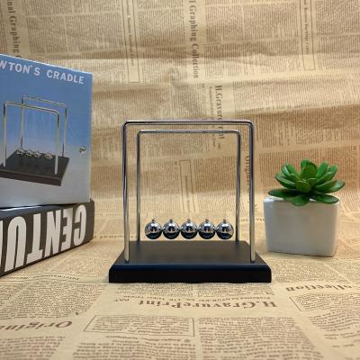 China Newton's Cradle Pendulum Ball With Wooden Logo Physics Science Newton Engraved Europe Gifts Toys Portable Metal Bottom for sale