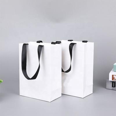 China Black Handmade Cardboard Paper Bag Custom Printed Logo Clothing Packaging Gift Carrier Bag Shopping Paper Bags Luxury for sale