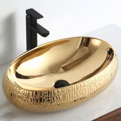 China GX2164 China Art Bathroom Sink Luxury Modern Ceramic Vanity Wholesale Prices Gold Oval Table Top Wash Basin for sale