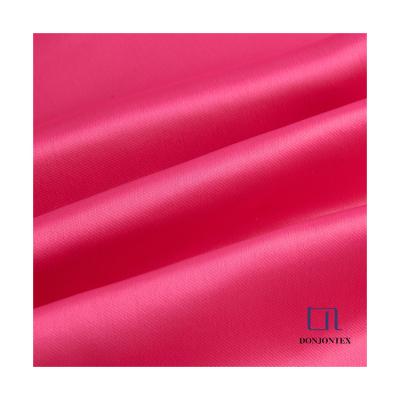 China Anti-Static Luxury Shinning Satin Fabric Wholesale Material 100% Polyester For Women Wear for sale