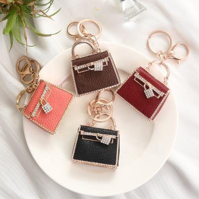 China 2021European Central Statistical Institute of Leather and American Popular Creative Women's Metal Car Pendant Small Gift Leather Bag Customized Key Chain for sale