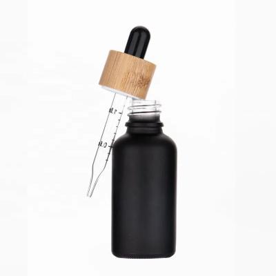 China Lotion Cream Best Selling Essential Oil Black Serum Frosted Glass Dropper Bottle With Bamboo Lid for sale