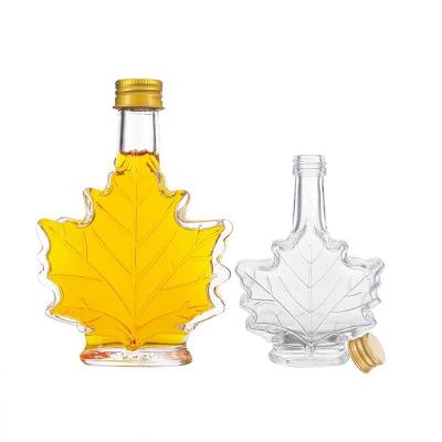 China Daily Life Hot Sale Maple Leaf Shaped 50ML 100ML Clear Glass Bottles For Syrup Bottle for sale